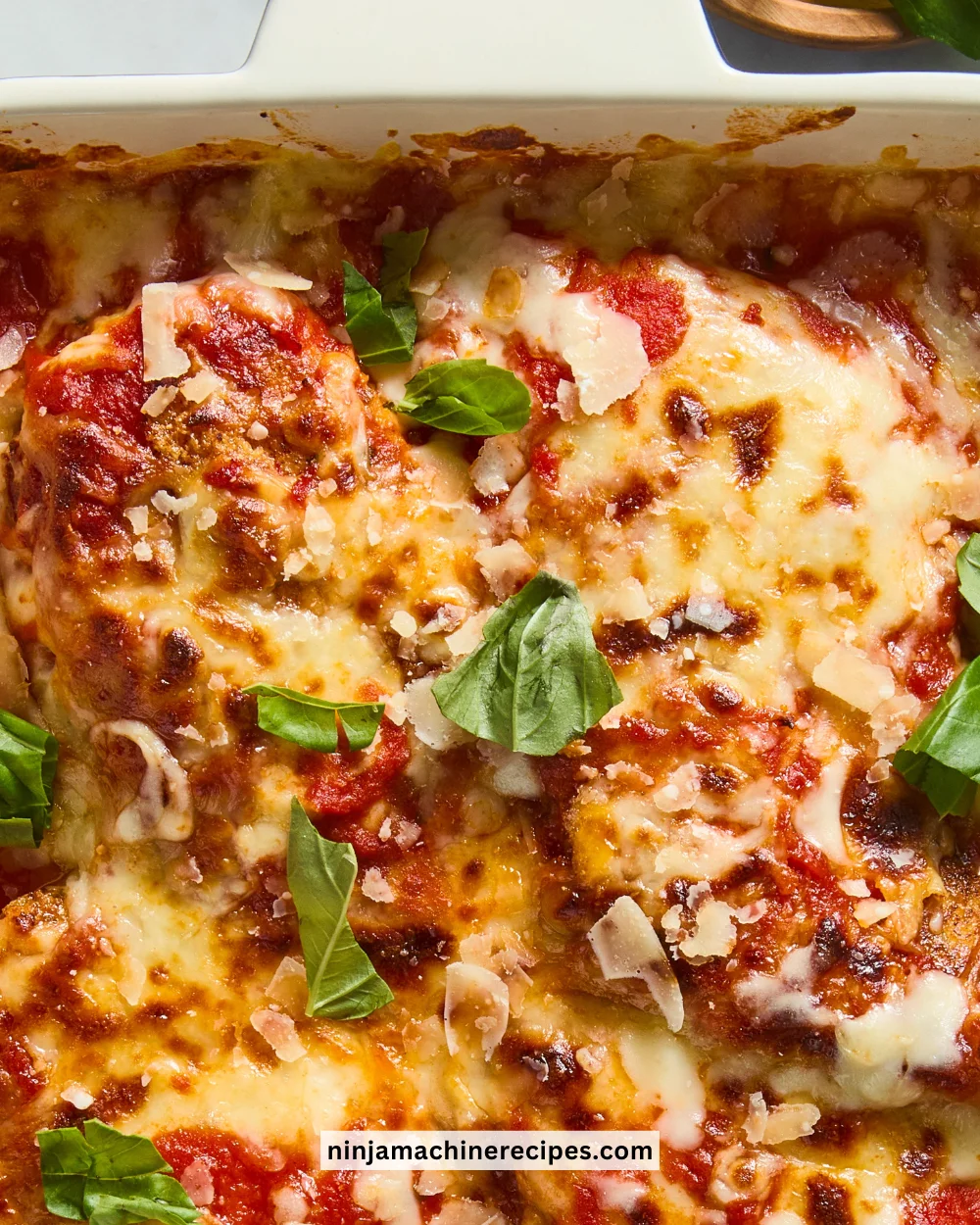 Delicious Keto Chicken Parmesan served with fresh herbs and cheese