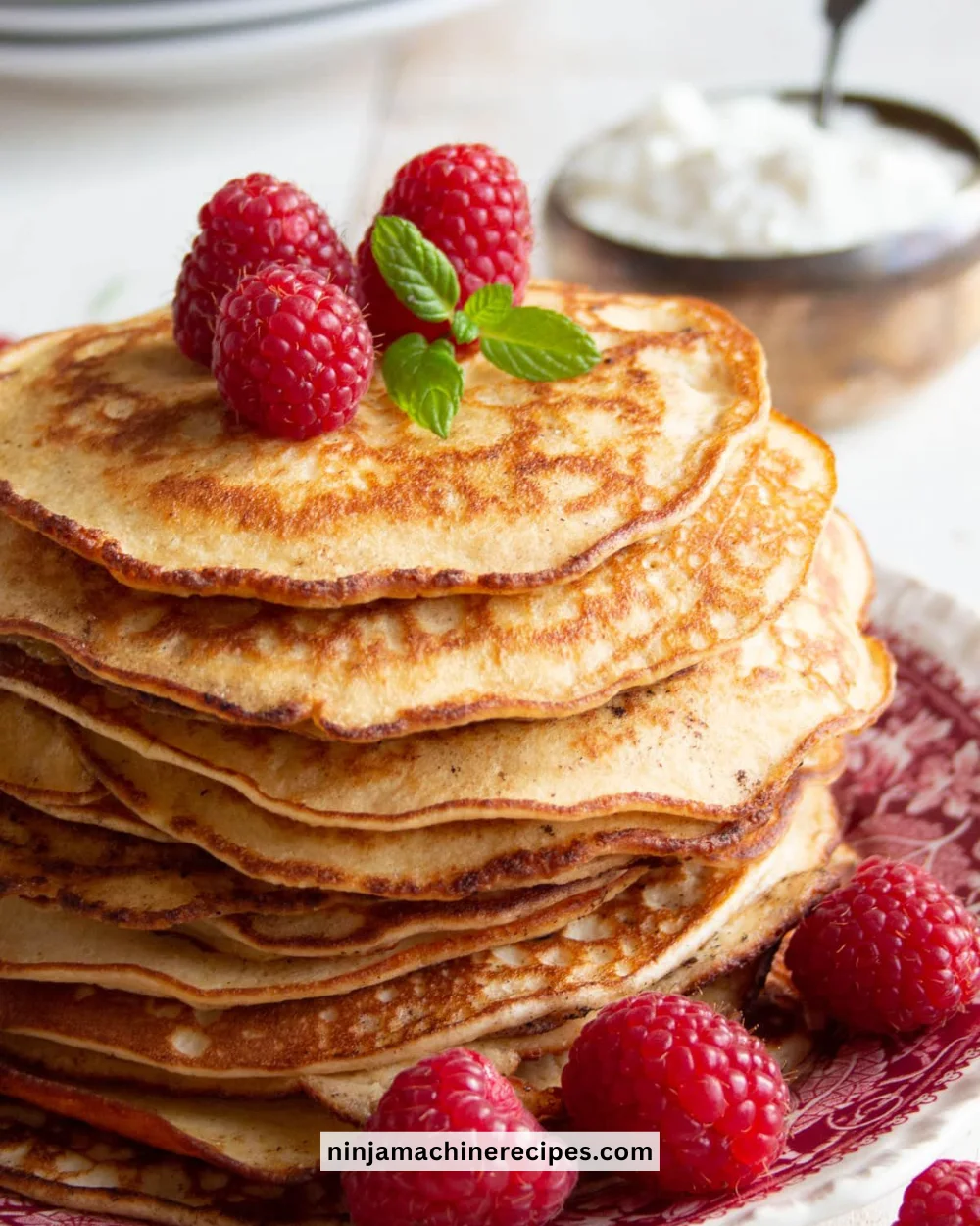 Plate of keto cream cheese pancakes topped with fresh berries