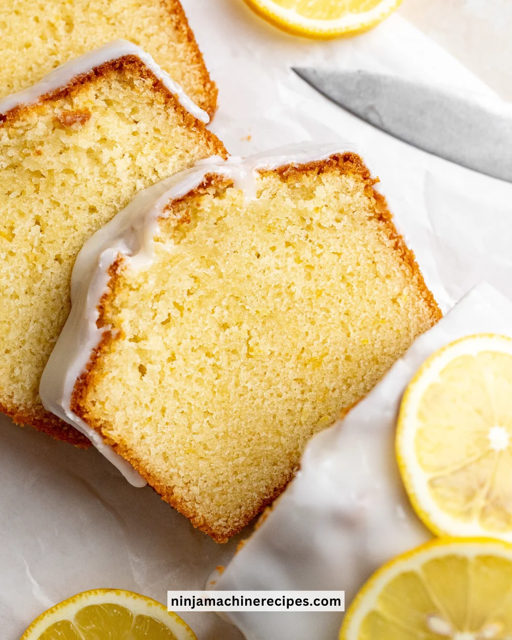 Delicious lemon loaf slice on a plate with lemon slices