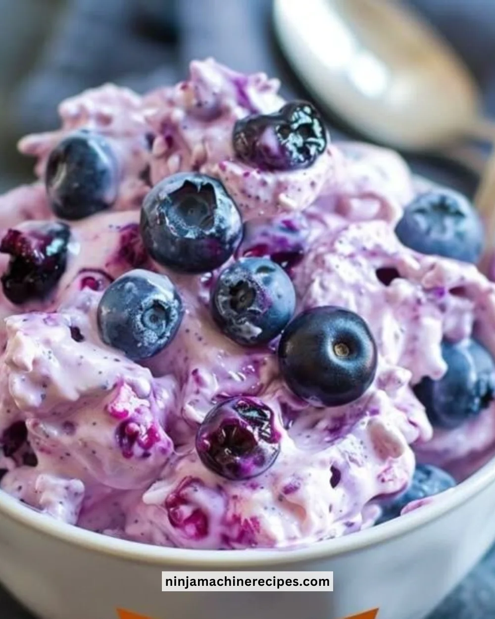 A bowl of light and refreshing dessert topped with fruits and mint leaves.