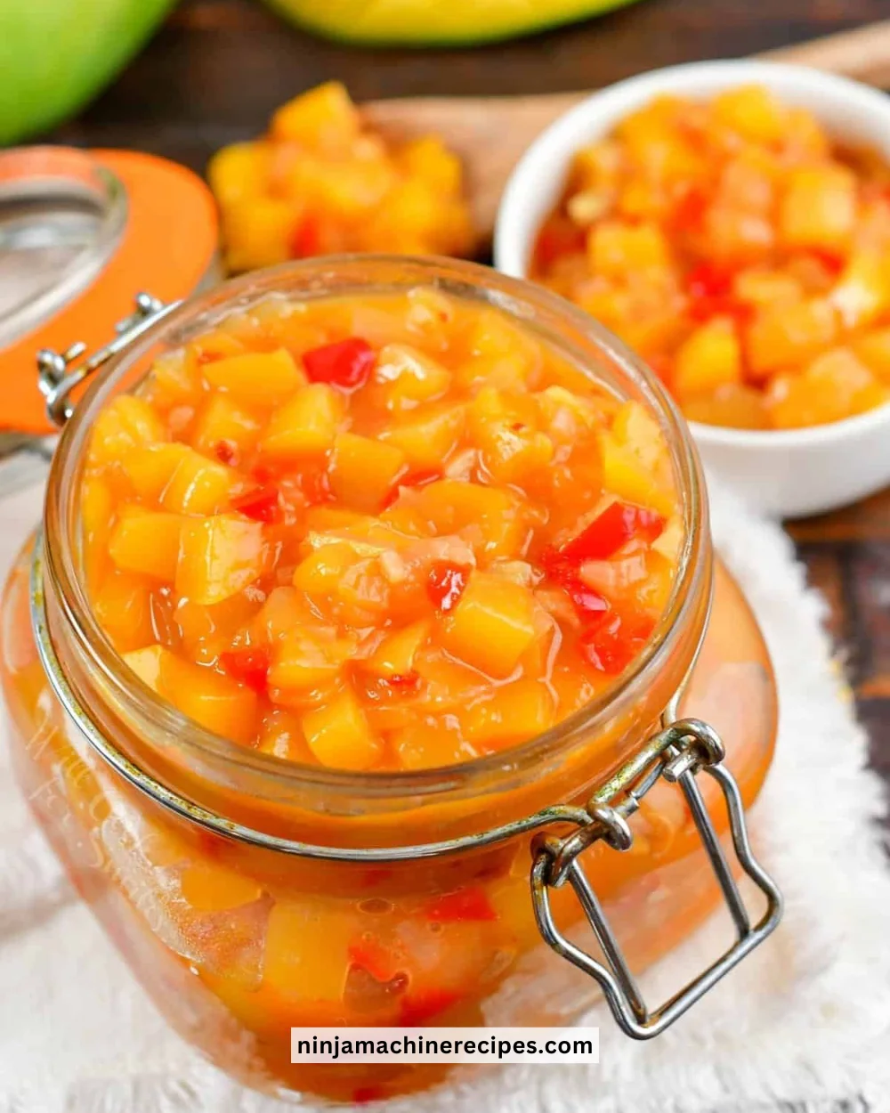 Homemade Mango Chutney served in a jar with fresh mango slices
