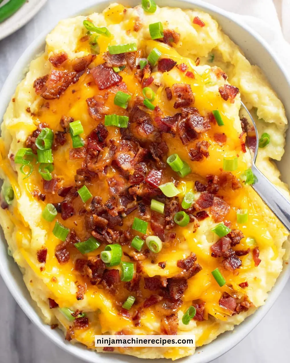 A bowl of creamy homemade mashed potatoes served with gravy.