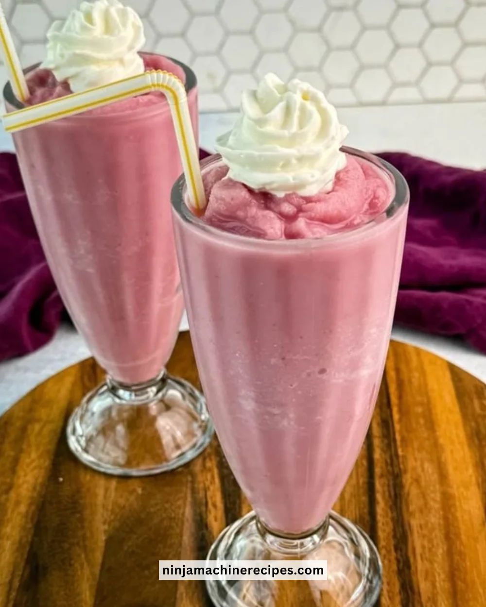 Creamy strawberry milkshake from Ninja Slushi topped with whipped cream and strawberries
