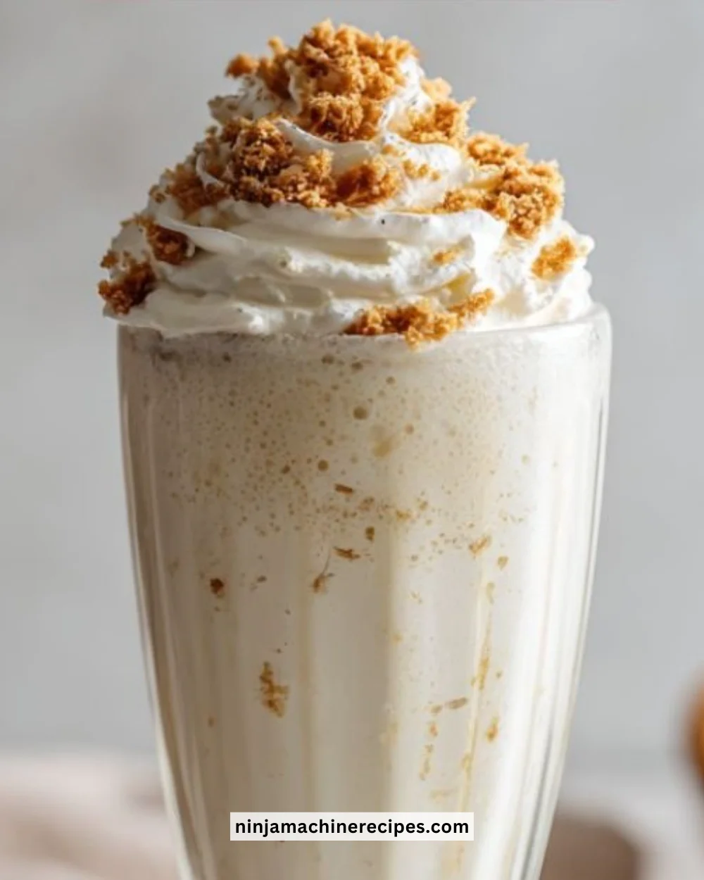 Ninja Slushie Vanilla Milkshake topped with whipped cream and a cherry