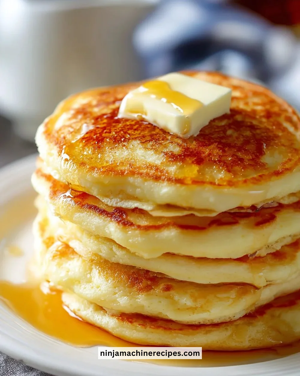Stack of fluffy old-fashioned pancakes with syrup and berries on a plate