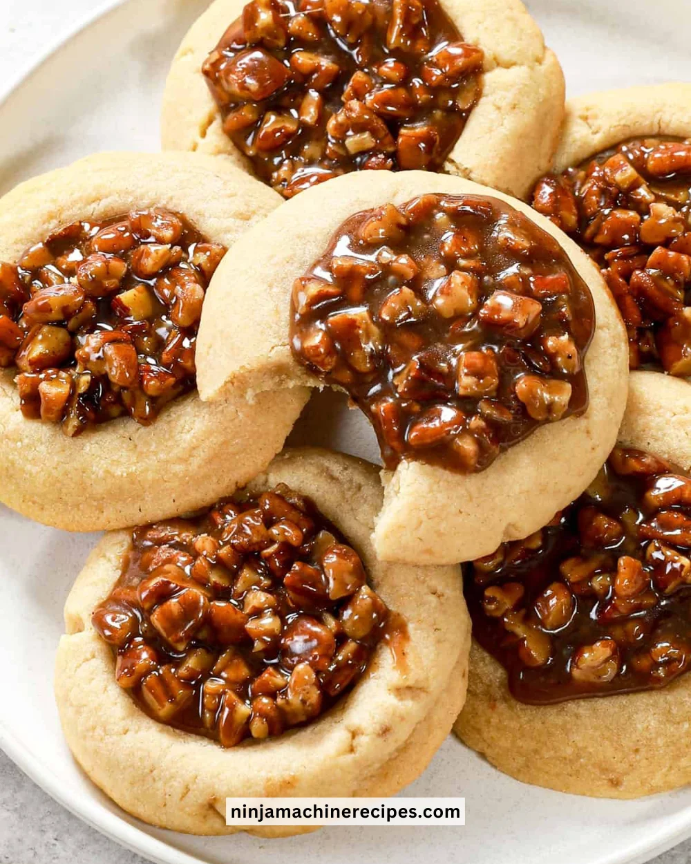 Freshly baked pecan pie cookies topped with chopped pecans and caramel