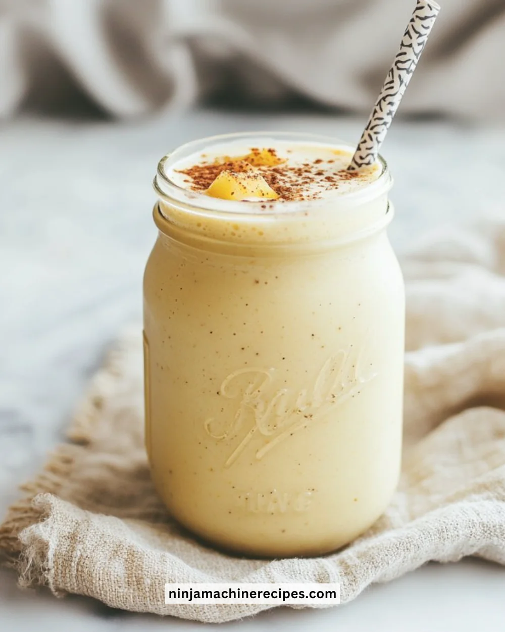 Delicious Pineapple Coconut Smoothie in a glass with tropical fruits