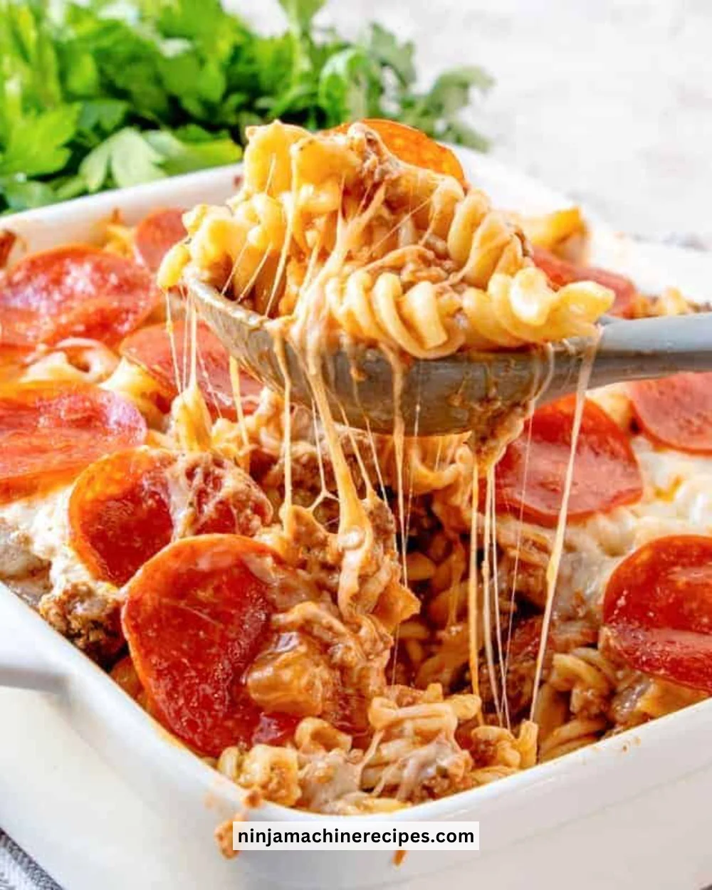 Delicious Pizza Pasta Bake topped with cheese and herbs, ready to serve.