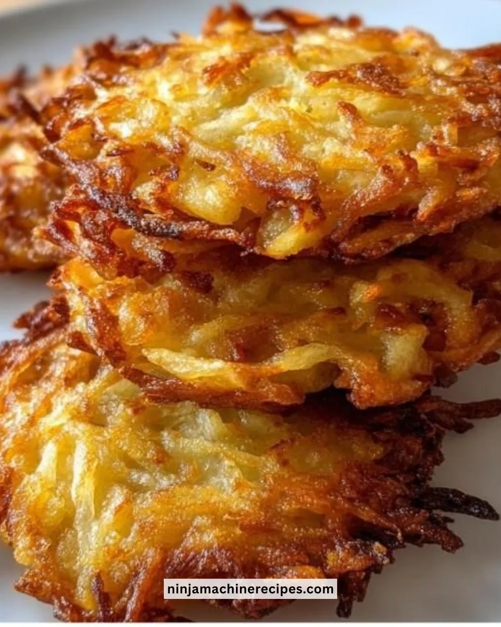 Crispy golden-brown potato latkes served with sour cream.