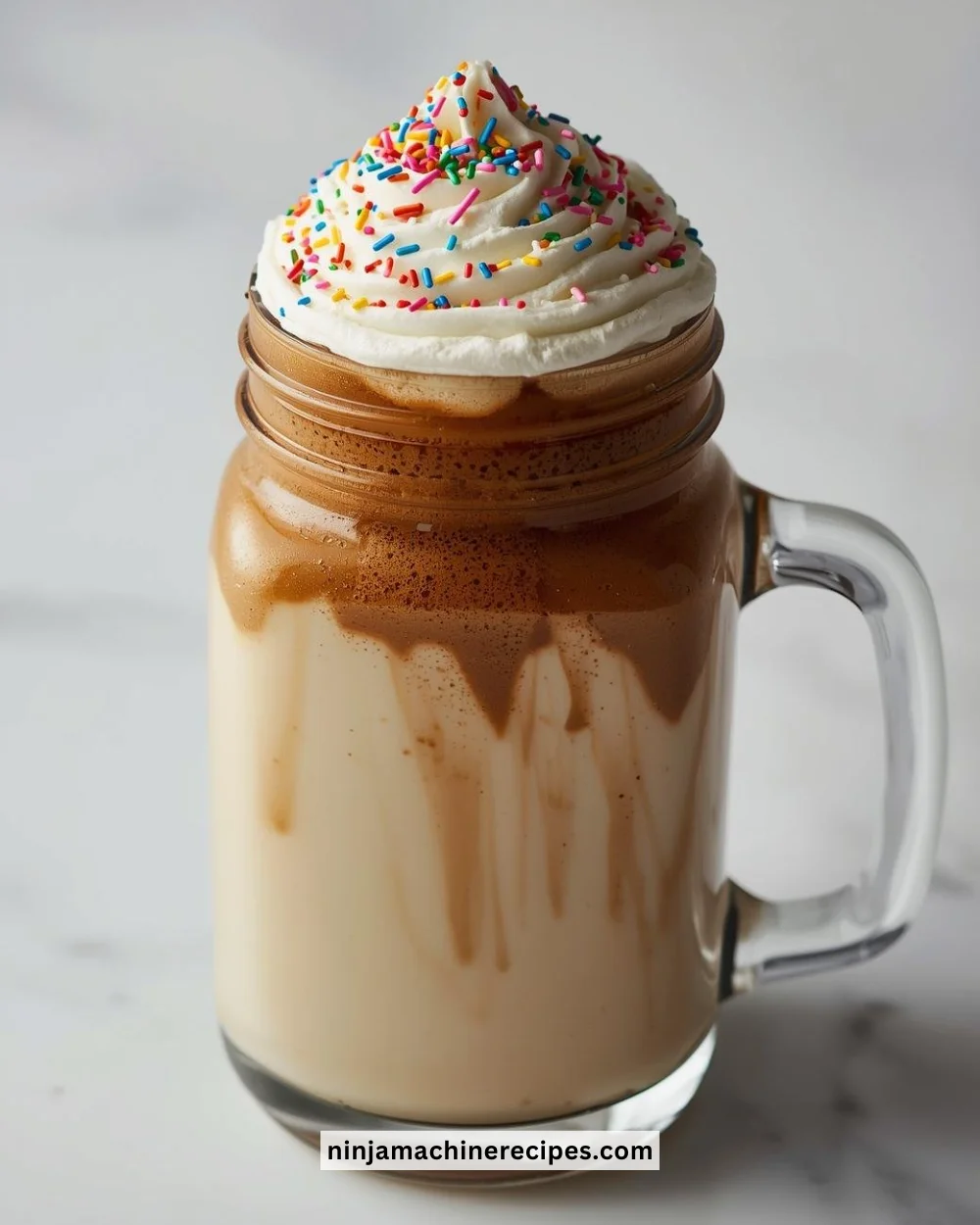 A delicious protein cake batter coffee served in a mug, topped with whipped cream.