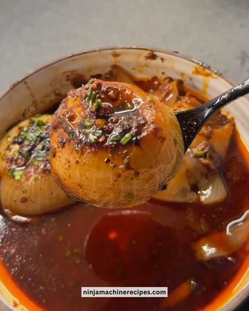 Delicious roasted whole onions served in a rustic dish, showcasing golden caramelization