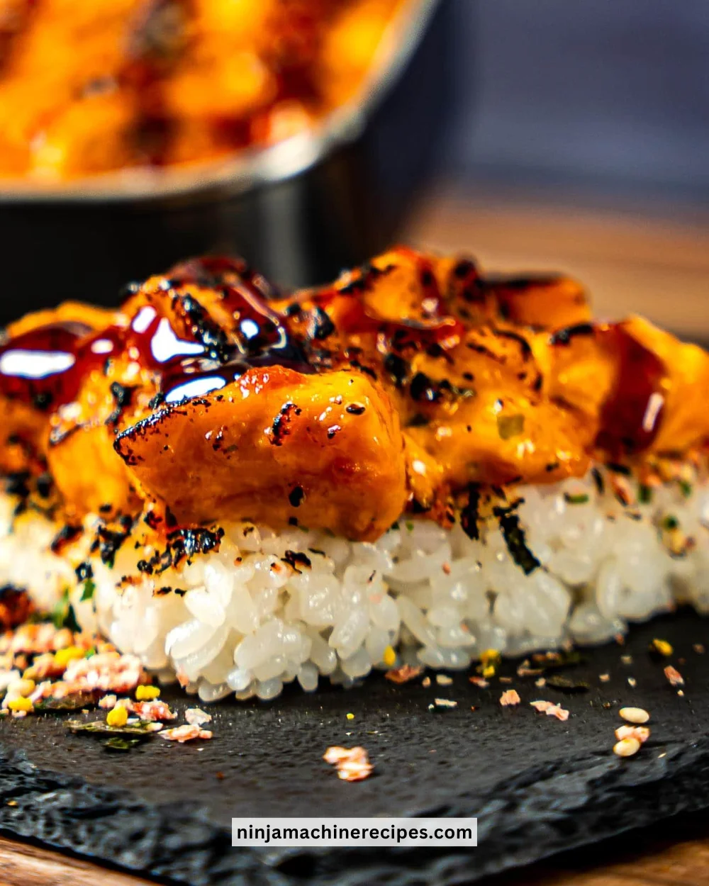 Delicious salmon sushi bake topped with fresh ingredients and served in a dish.