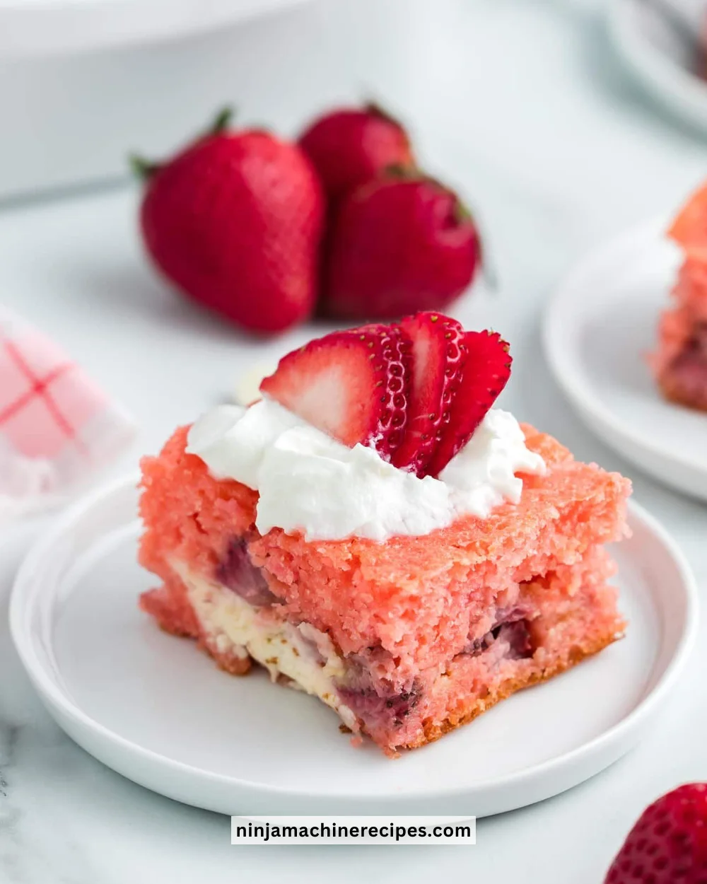 Delicious Strawberry Earthquake Cake topped with fresh strawberries and whipped cream