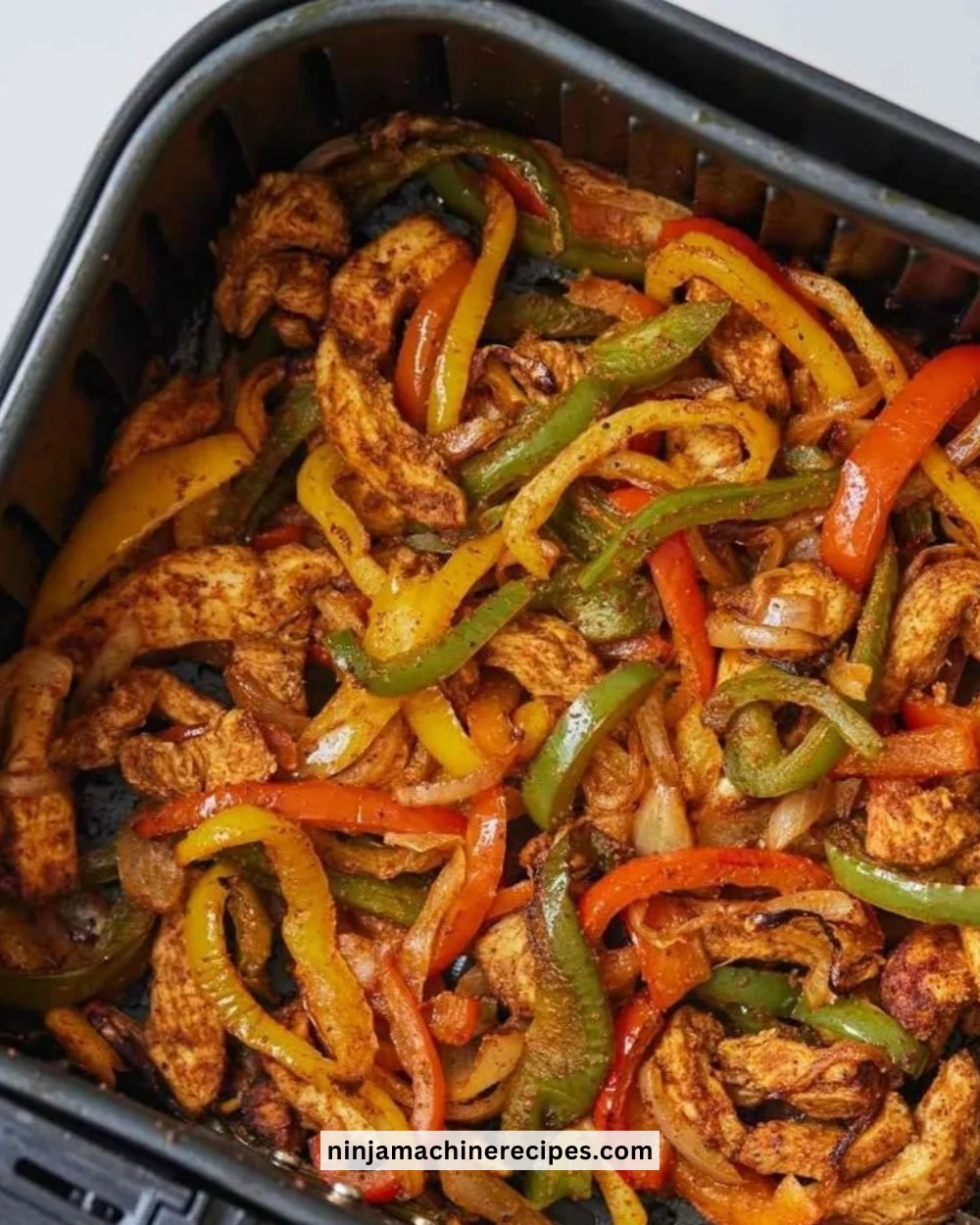 Delicious air fryer chicken fajitas served with fresh vegetables and tortillas.