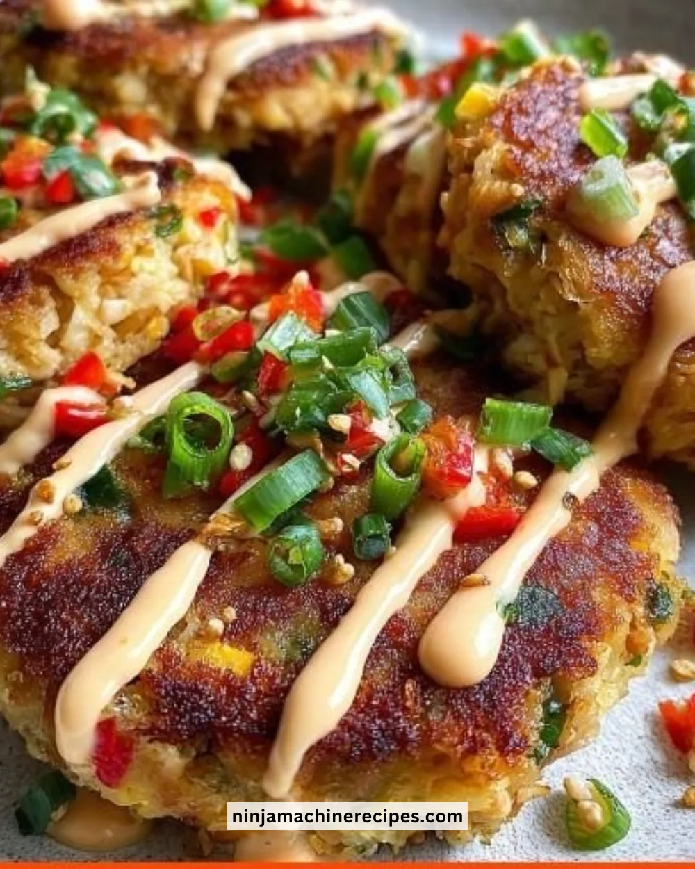 Asian-style tuna cakes served with spicy mayo on a plate