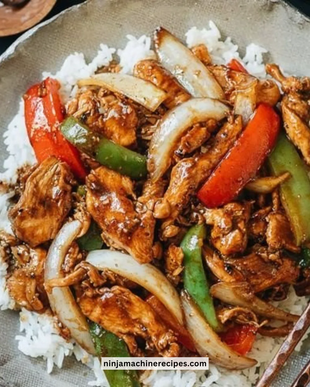 Delicious plate of black pepper chicken garnished with herbs