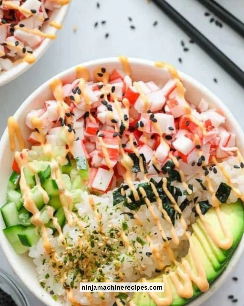 California Roll sushi bowl featuring rice, avocado, crab, and fresh vegetables