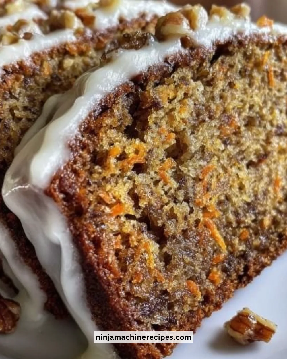 Slice of carrot cake banana bread topped with cream cheese frosting