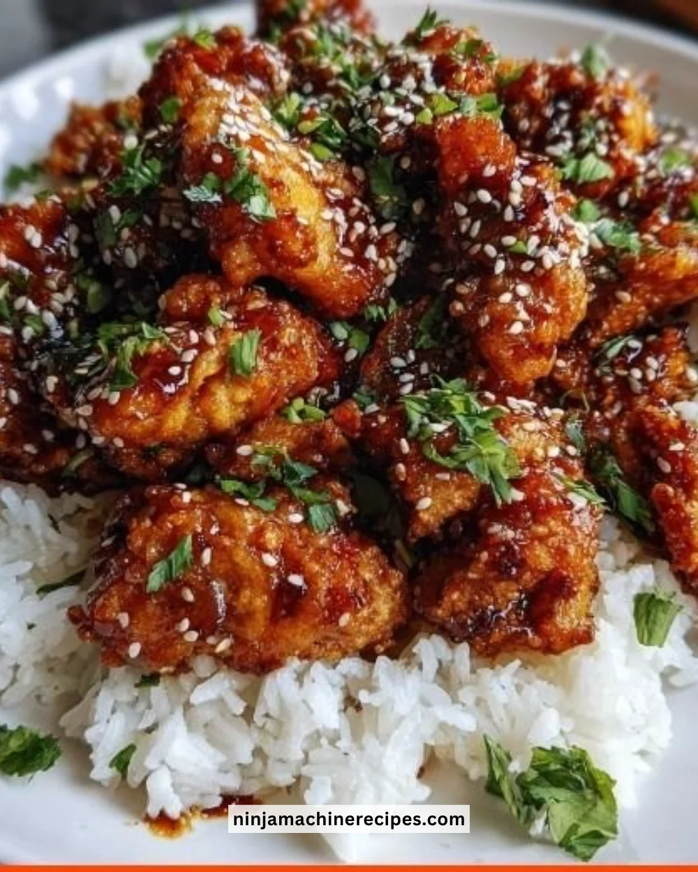 Delicious plate of Chinese Takeout Sesame Chicken with sesame seeds and vegetables