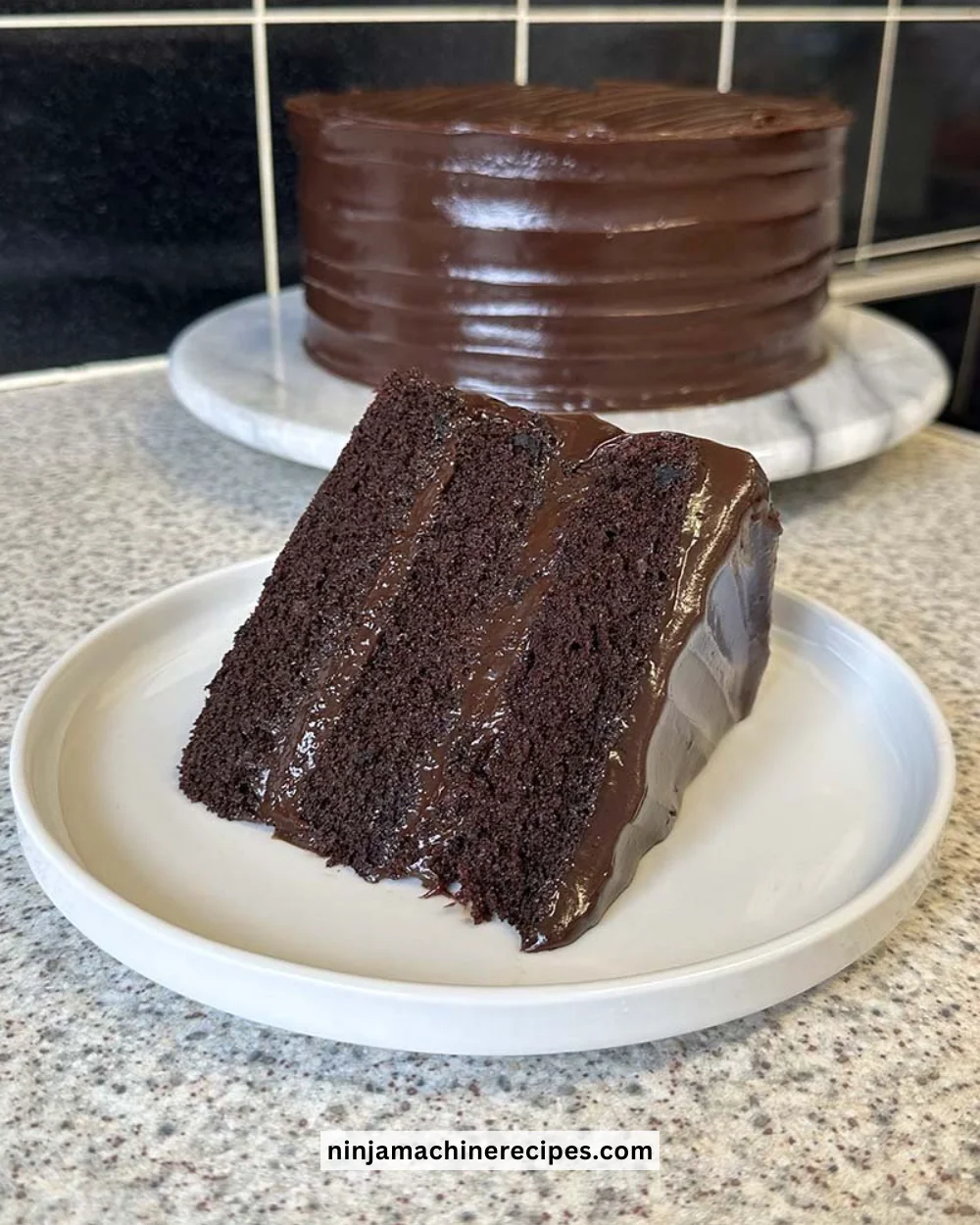 Delicious slice of chocolate fudge cake topped with chocolate ganache