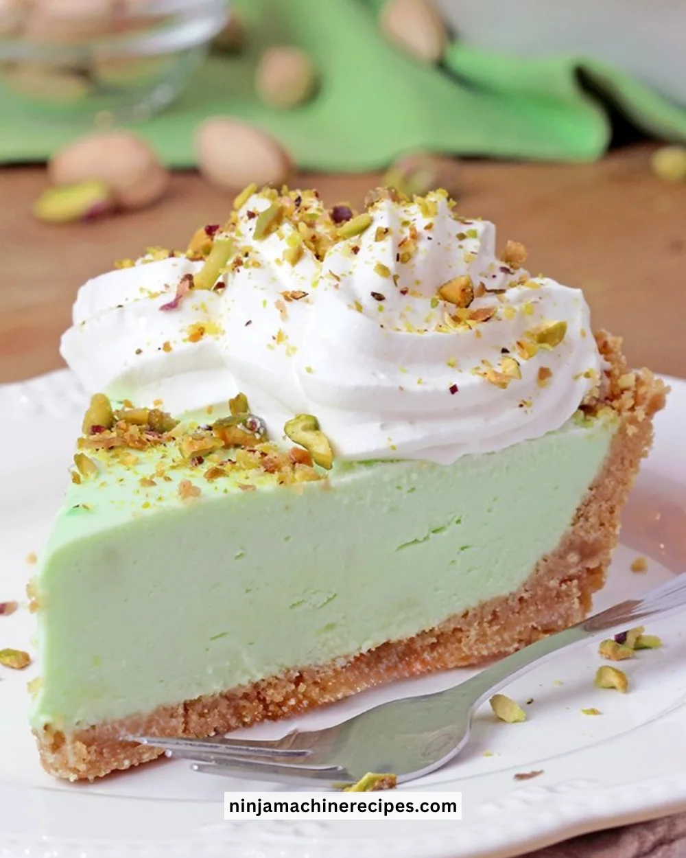 No bake pistachio cream pie with a graham cracker crust and whipped cream topping