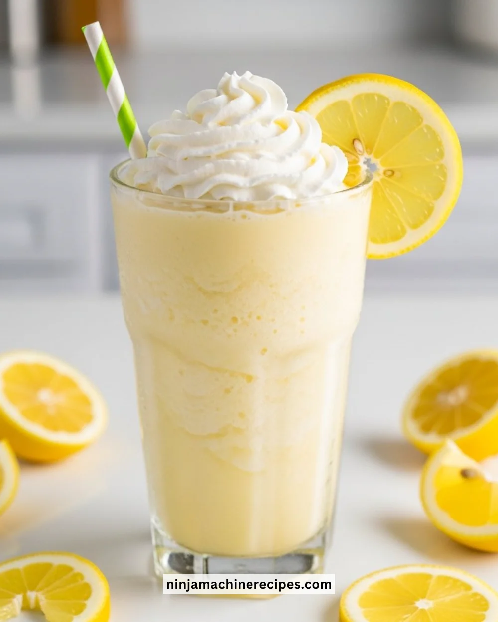 Frosted lemonade in a glass with ice, garnished with lemon slices and mint
