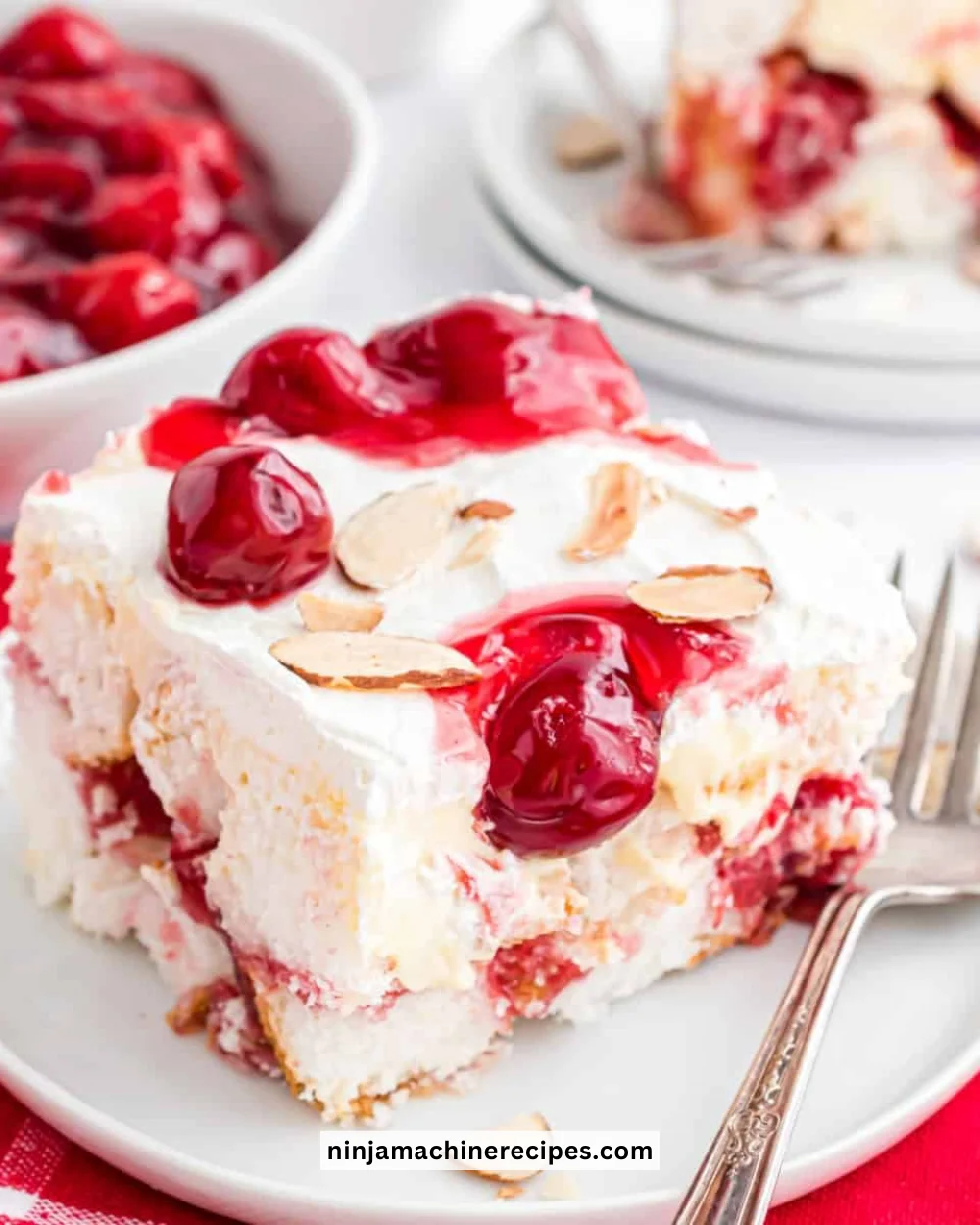 Delicious Heaven On Earth Cake topped with whipped cream and cherries.
