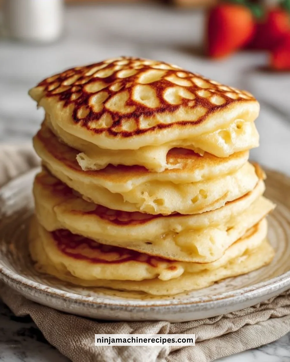 High-protein fluffy pancakes served with syrup and fresh fruit