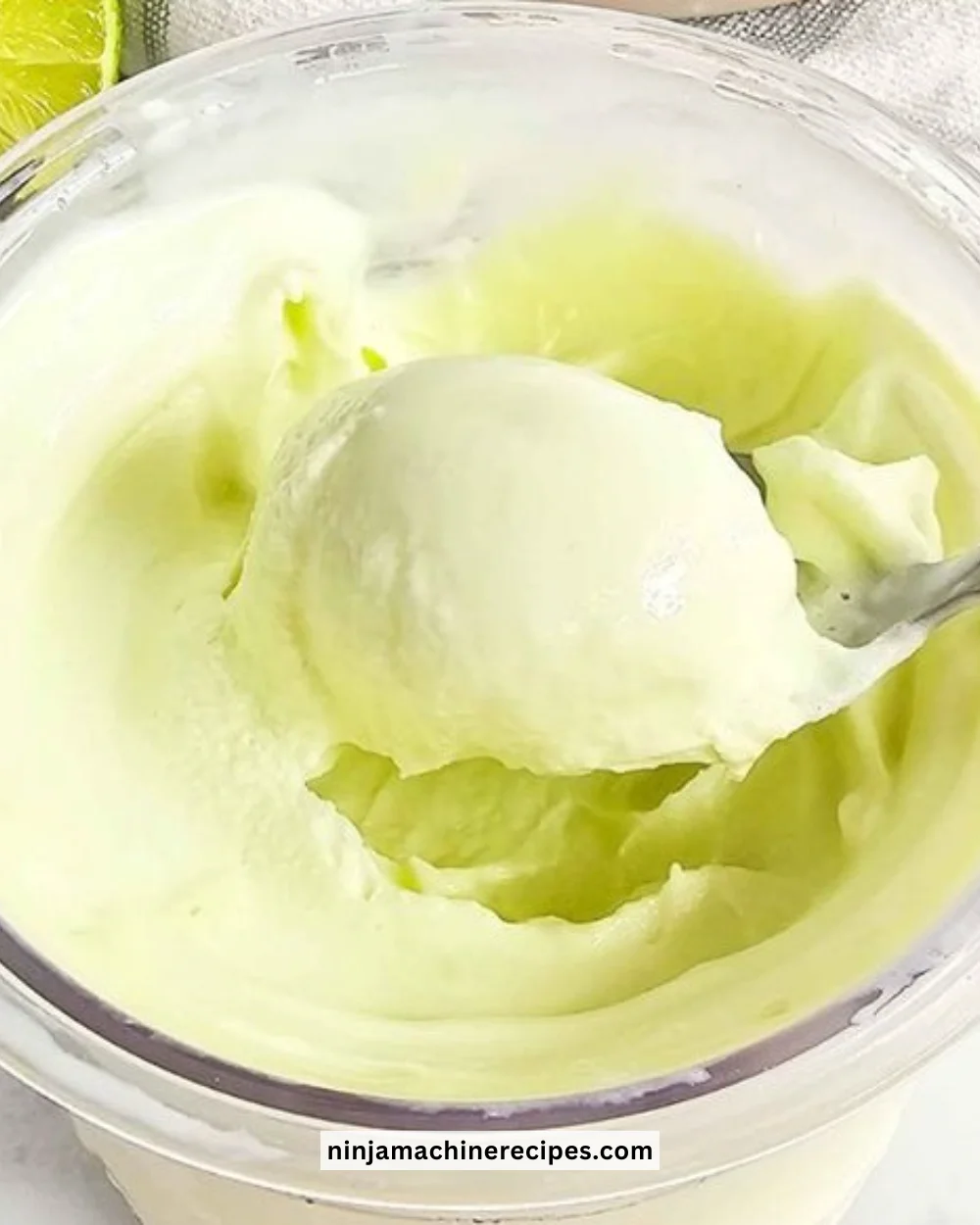 Delicious Key Lime Pie Ice Cream served in a bowl with lime slices on top.