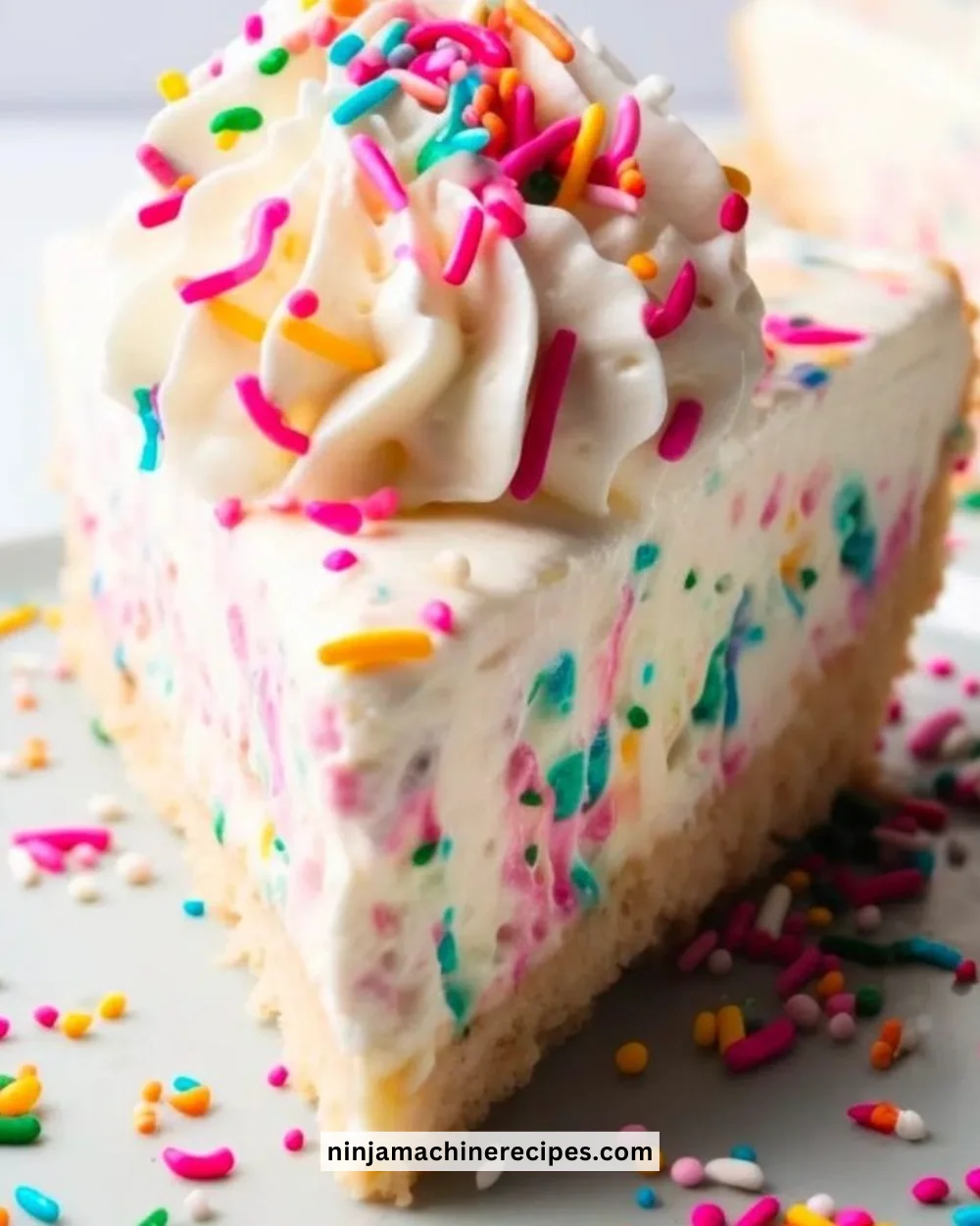 No Bake Funfetti Cheesecake topped with colorful sprinkles