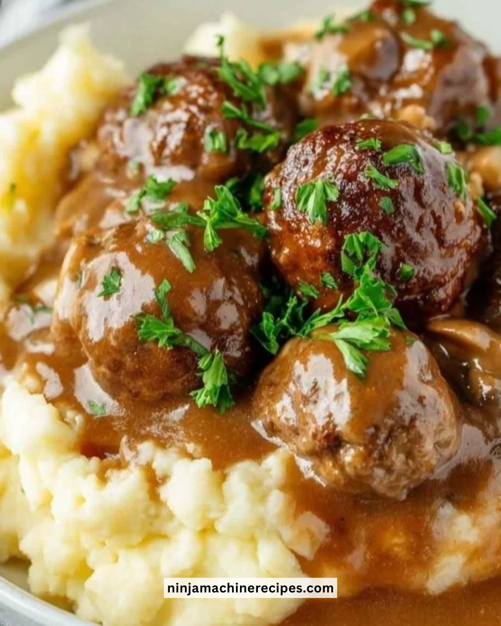 Delicious slow cooker Salisbury steak meatballs served with gravy and mashed potatoes.