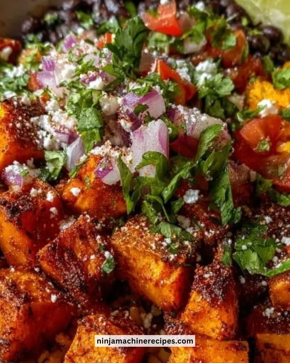 Colorful sweet potato taco bowl topped with fresh ingredients and avocado.
