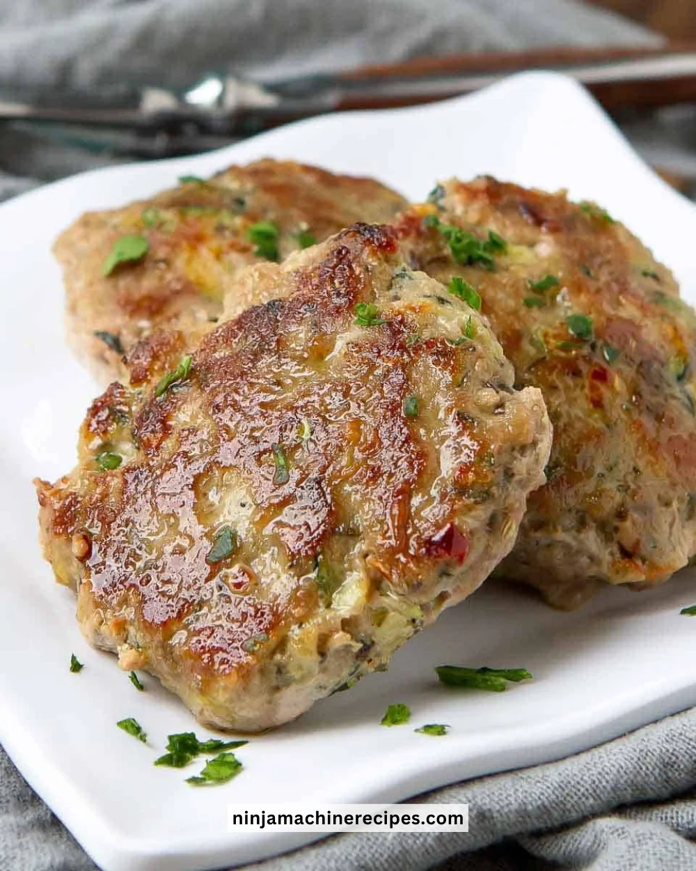 Plate of turkey breakfast sausage patties served with eggs and greens.