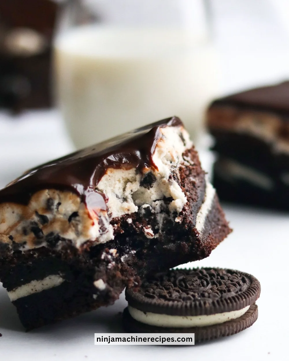 Delicious Ultimate Oreo Cookie Brownies topped with crushed Oreo cookies.