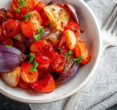 Roasted air fryer tomatoes and onions served in a bowl
