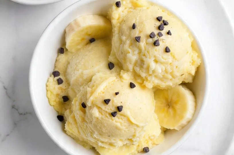 A bowl of creamy Banana Nice Cream topped with fresh fruits.