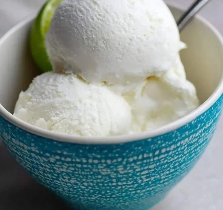 Delicious coconut lime ice cream served in a bowl topped with lime zest