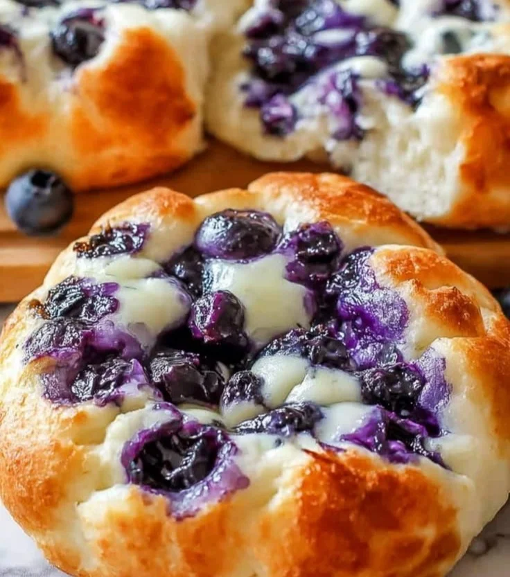 Fluffy cottage cheese blueberry cloud bread with fresh blueberries.