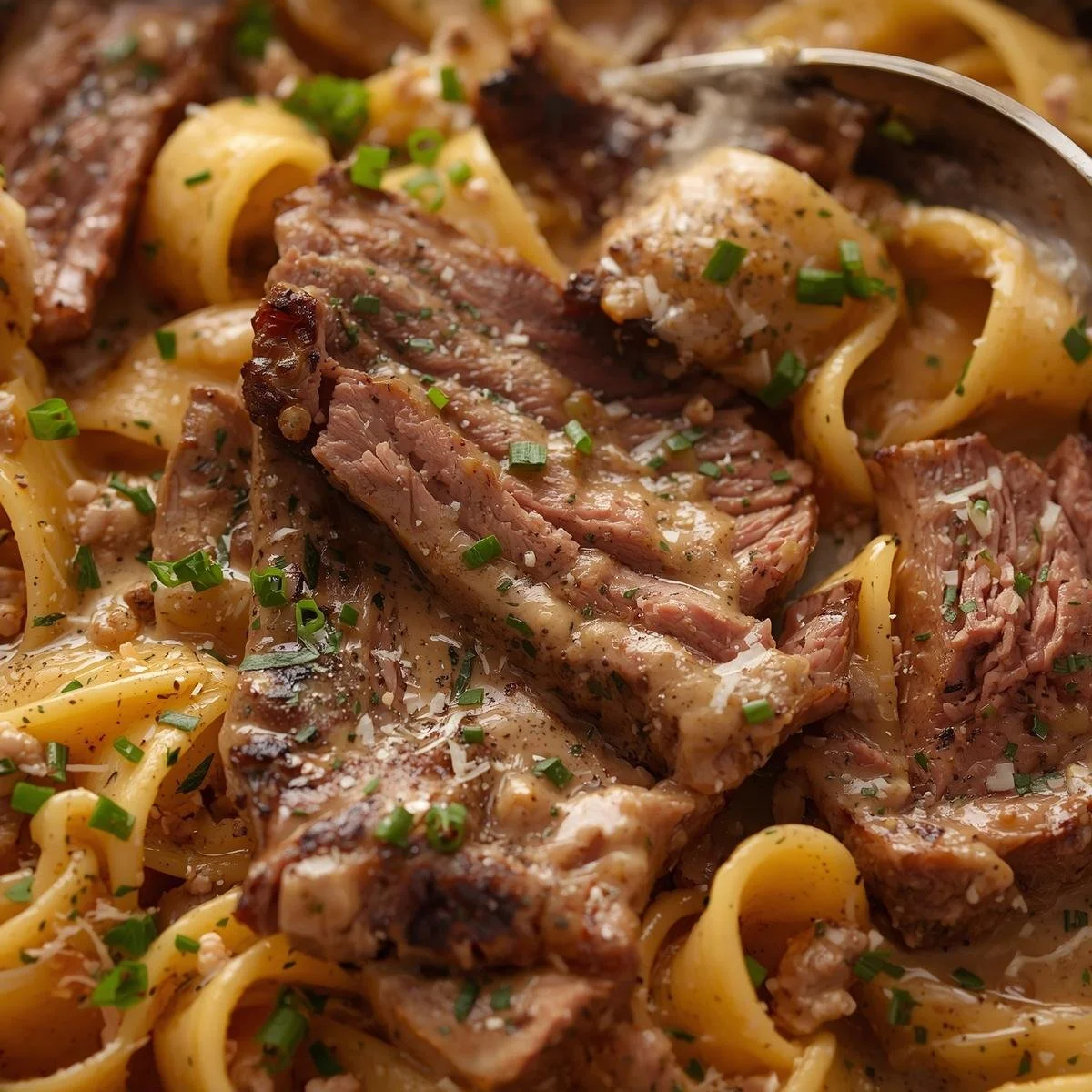 Creamy Cowboy Butter Steak Pasta garnished with herbs and served in a bowl.