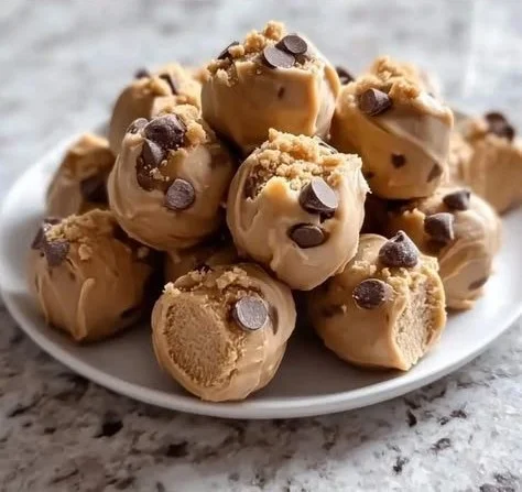 Frozen Greek yogurt peanut butter bites in a bowl with fresh ingredients