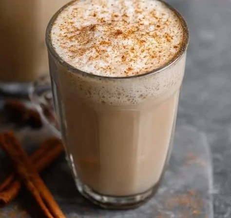 Homemade chai tea latte with spices and frothy milk in a cup