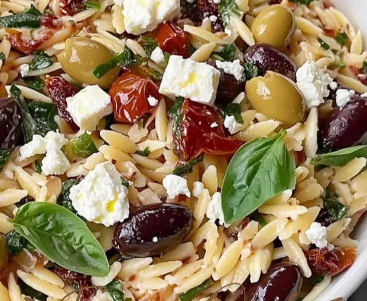 Homemade orzo pasta salad with feta cheese and sun-dried tomatoes