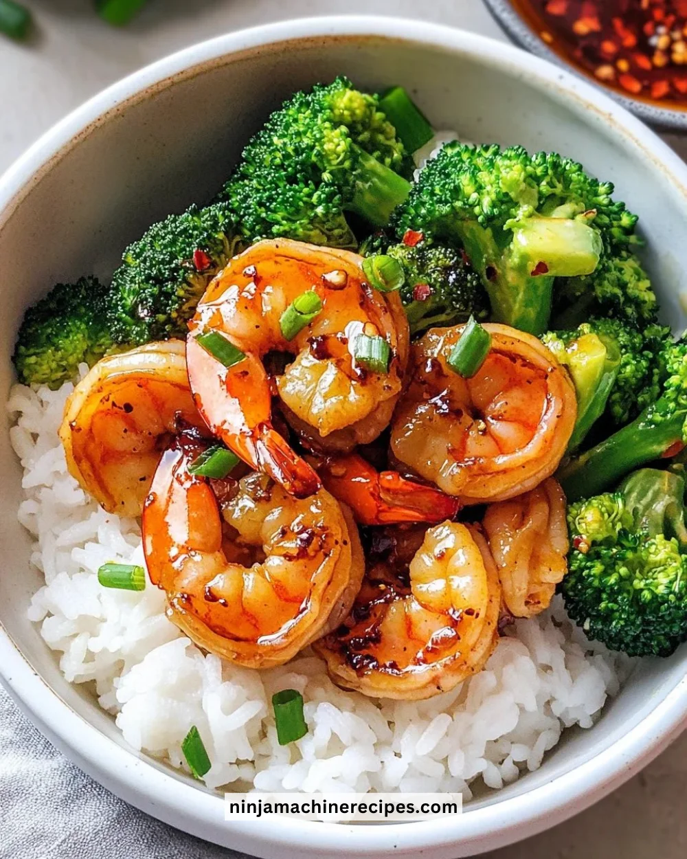 Delicious Honey Garlic Shrimp Bowl garnished with fresh vegetables.