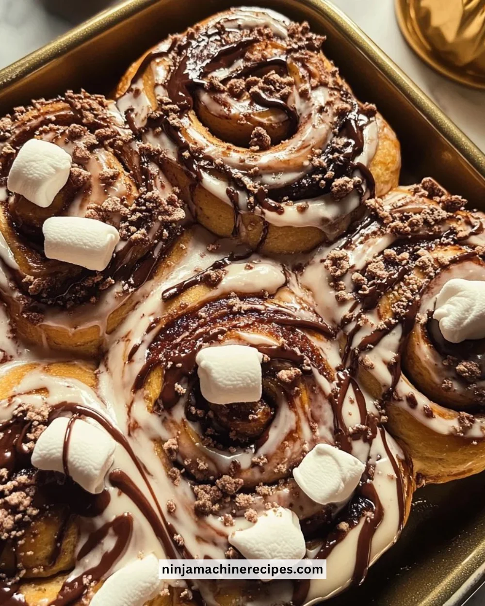 Hot cocoa cinnamon rolls with vegan marshmallows frosting on a plate
