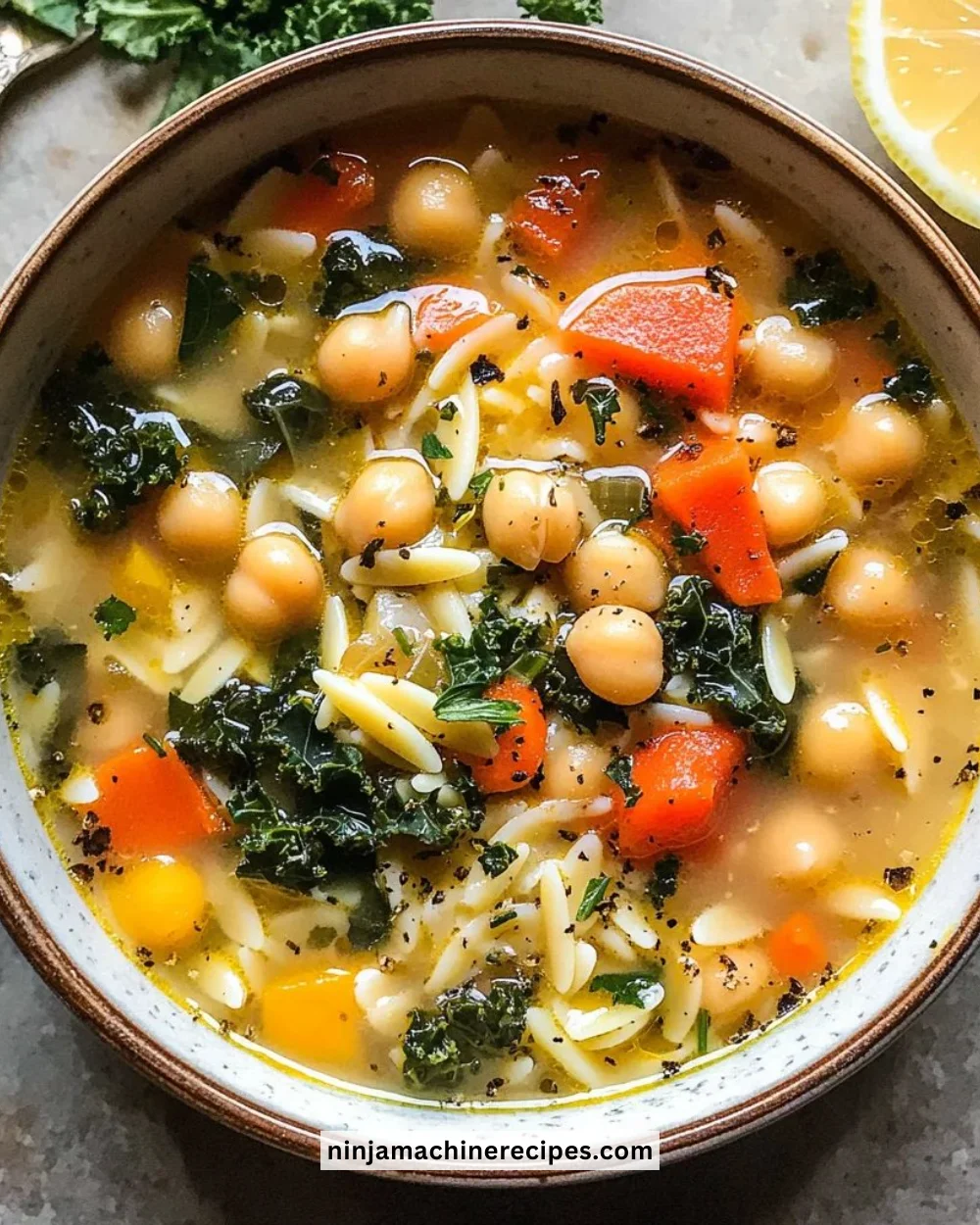 Bowl of Lemony Greek Chickpea Soup garnished with fresh herbs.