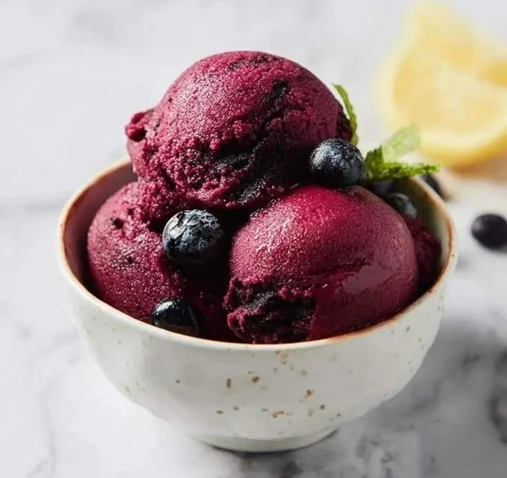 Ninja Creami Blueberry Lemon Sorbet served in a bowl with fresh blueberries