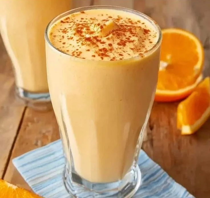 Delicious Orange Creamsicle Smoothie in a glass garnished with orange slices.