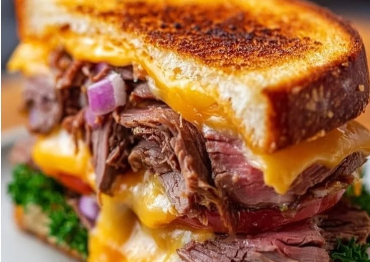 Juicy Roast Beef Cheddar Melt sandwich with melted cheese and fresh ingredients