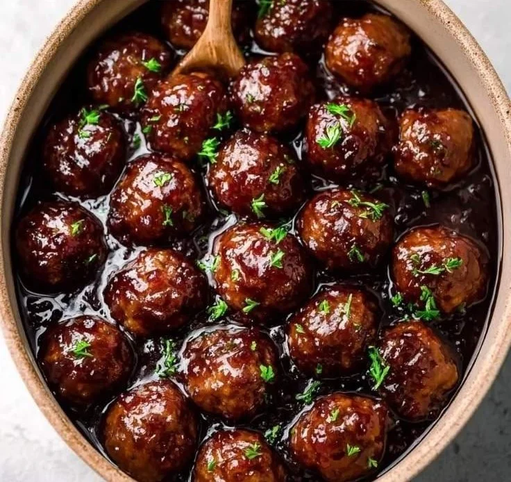 Delicious grape jelly meatballs cooked in a slow cooker for a sweet and tangy flavor.