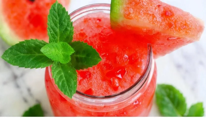 Refreshing Watermelon Mint Slushie in a glass with mint leaves and watermelon slices